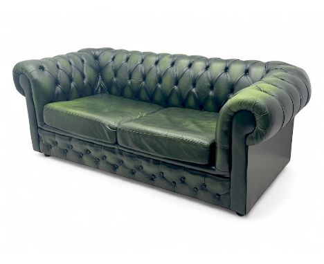 Two seat Chesterfield design sofa bed, upholstered in emerald green leather with deep-buttoned detailing, rolled arms, two lo