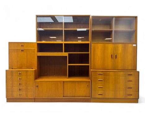 Mid-20th century modular teak wall unit, comprising four sliding glazed display cabinets, open shelving, drop-front storage, 