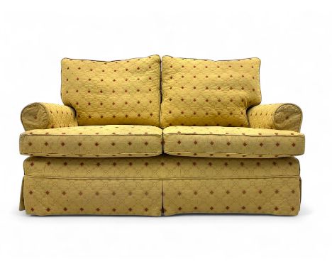 Two-seater upholstered sofa, loose cover in a pale gold quilted fabric with diamond pattern, rolled arms, skirted base, on ca