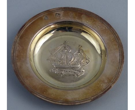 A trinket dish, of circular form, the centre embossed with a galleon in full sail within line incised flared rim, 10cm wide, 