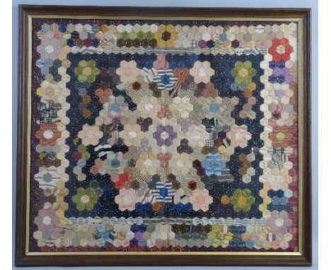A patchwork panel, composed of numerous different coloured hexagonal sections depicting a geometric pattern with large hexago