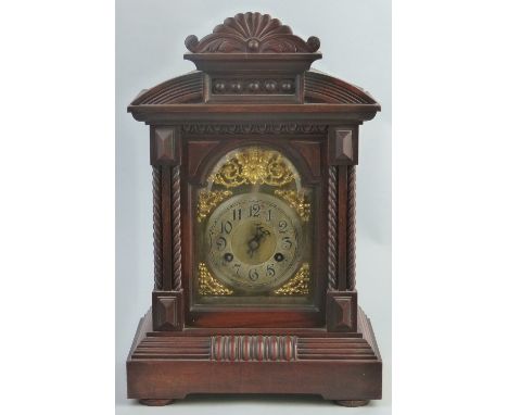 A late 19th/early 20th Century mantel clock, with German brass eight day movement striking on a single gong, arched brass dia