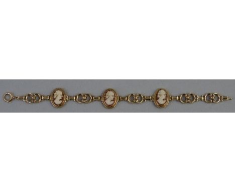 A 10k gold bracelet, comprising three oval portrait cameos joined by fancy links, 19.5cm long