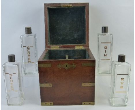 A 19th Century mahogany decanter box, of cuboid form with brass mounted corners and escutcheon, the hinged lid opening to rev
