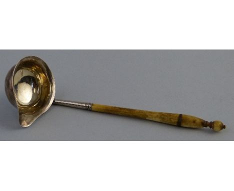 A Georgian toddy ladle, the turned ivory haft having circular lipped bowl, 15cm long, marks rubbed (only duty mark visible)