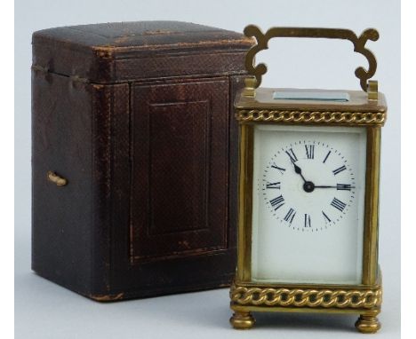 An early 20th Century carriage clock, of oblong form, the white enamelled dial with Roman numerals enclosing a brass eight da