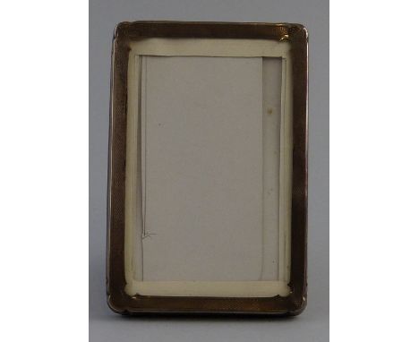 A photograph frame, of oblong form with oblong aperture engine turned with shell banding having strut support, 15cm x 10cm, B
