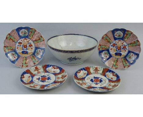 A pair of Japanese Imari plates, each of fluted circular form with central panel of a vase of flowers surrounded by other flo