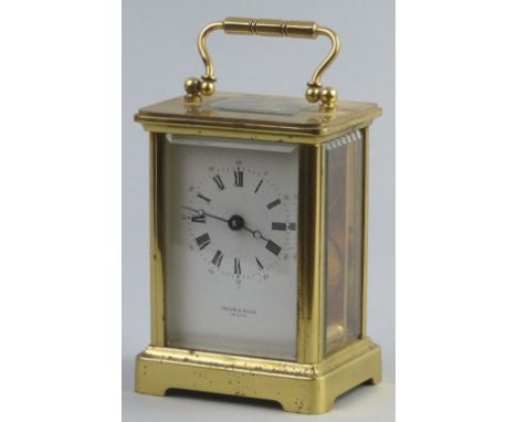 A 20th Century carriage clock, of oblong form, the white enamelled dial with Roman and Arabic numerals inscribed "Taylor & Bl