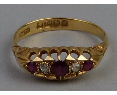 An Edwardian ruby and diamond ring, comprising three graduated rubies divided by two diamonds claw set on 18ct gold shank wit