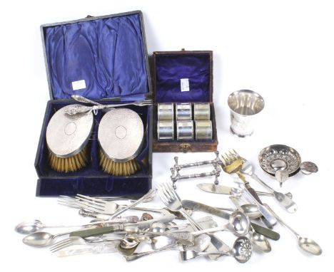 An assortment of silver plate and a pair of hammered-silver mounted oval clothes brushes. The clothes brushes with hallmarks 