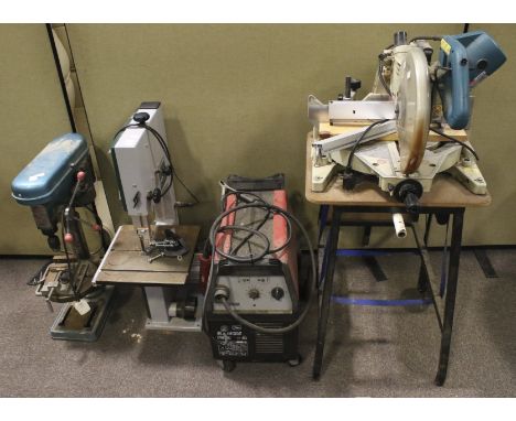 An assortment of Workshop tools. Comprising a Makita chop saw, Naerok pillar drill, Record band saw and a boxer 155 welder