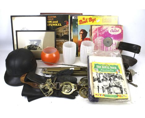 An assortment of collectables. Including a vintage motorbike helmet, LP records, prints, etc.