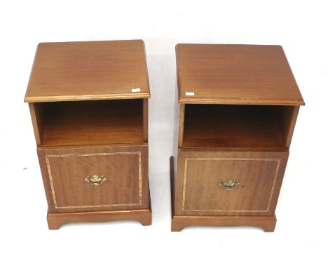 A pair of contemporary bedside cabinets. Both with a single shelf over a cupboard, raised on bracket supports, H64cm x W41cm 