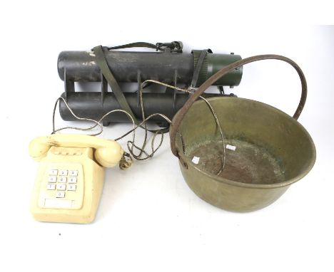 A preserve pan, vintage telephone and military carrier. The brass pot with a single handle to the top, H31cm, the telephone c