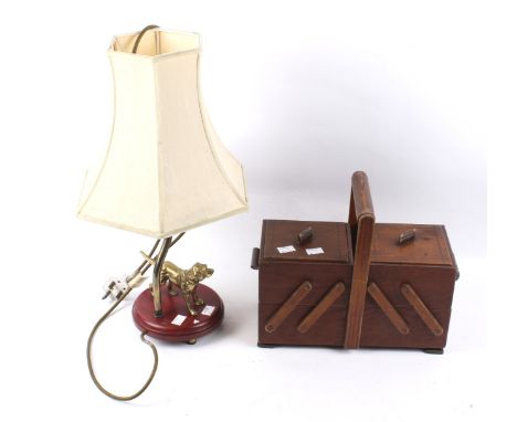 A vintage folding sewing work box and a table lamp. The wooden sewing box with a handle to the top, L31cm, the lamp featuring