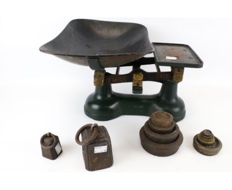 A set of green kitchen scales with a set of weights. Marked 'To WEIGH 14LB'. H24cm