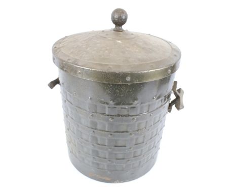 A vintage cast metal coal bin. Of cylindrical form with a lid and twin handles, decorated with impressed details, H42.5cm