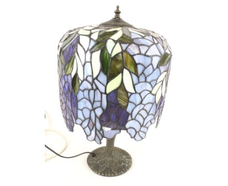 A Tiffany style table lamp. With leaded blue glass shade, mounted on a cast metal base, H51cm