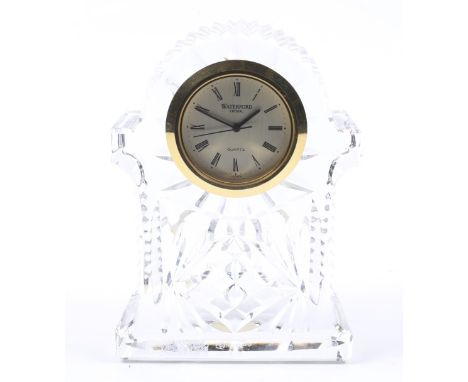 A Waterford crystal quartz desk clock. The signed and brushed-silvered round dial with black Roman numerals and sweep centre 
