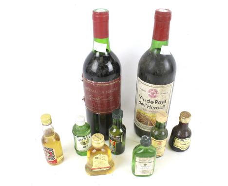 A collection of alcohol. Including a bottle of Chateau La Nauve 1990, Vin de Pays de l'Herault, Bells Scotch Whisky miniature