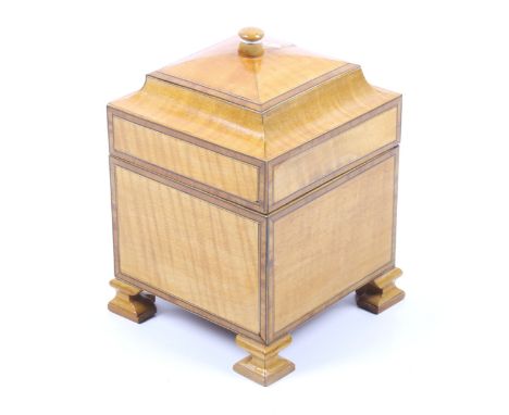 A vintage fruit wood tea caddy. With a hinged lid and banded decoration, raised on shaped feet, H18cm