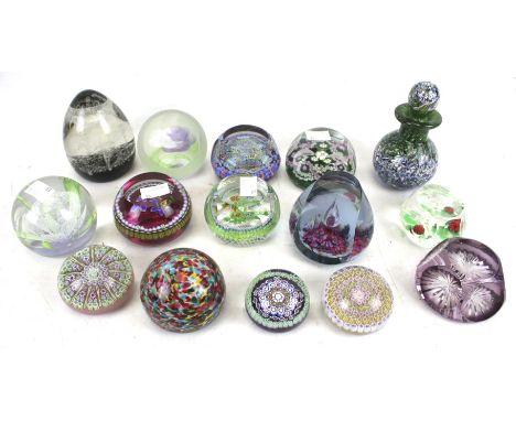 A collection of Perthshire and other caned glass paperweights and a small scent bottle. The paperweights of assorted sizes an
