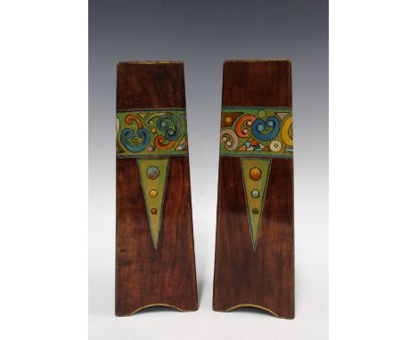 A pair of Art Nouveau wooden vases, triangular form and painted with a band of stylised flowers, 31cm  (2) 
