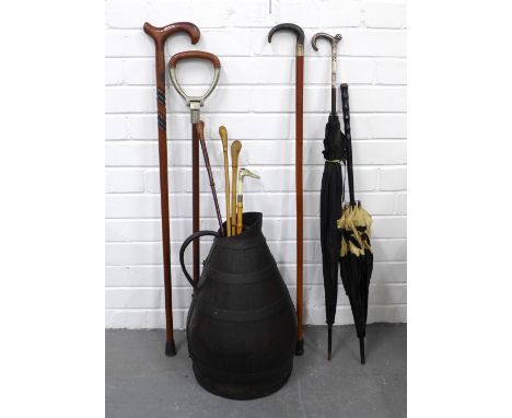 Metal bound wooden jug 49cm, with a vintage umbrella, walking sticks, shooting stick and riding crops,  etc 