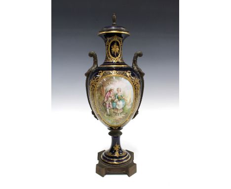 Sevres style porcelain urn vase with gilt metal surmounts, decorated with a figural panel against a blue ground, signed Luxe,