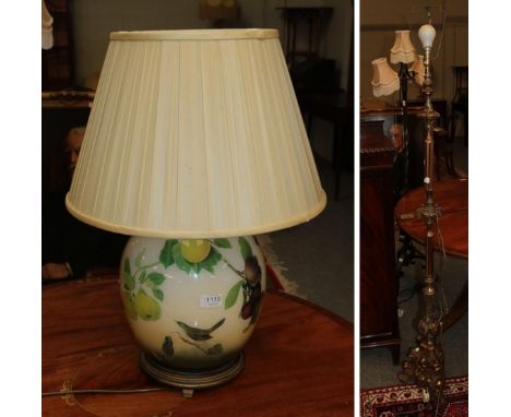 A wrought iron three branched standard lamp converted to electric and a gilt bezel, another gilt metal standard lamp and a mo