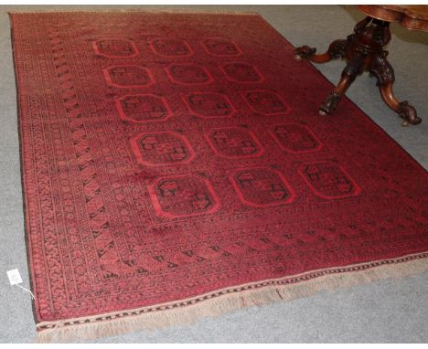 An Afghan Turkmen carpet, the field of quartered guls enclosed by multiple borders, 260cm by 209cm; together with a Baluch ru