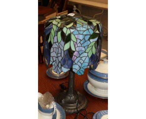 A large Tiffany style table lamp, the shade decorated in blues and greens