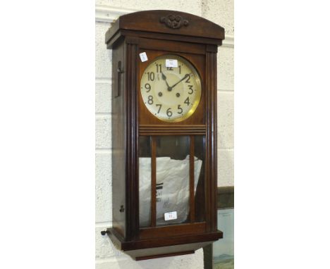 An oak-cased striking wall clock, 72cm high.
