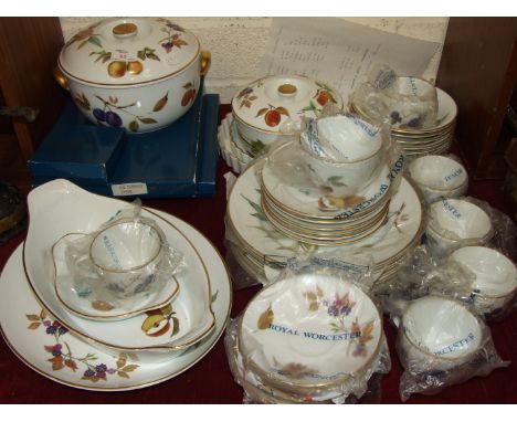 Thirty-eight pieces of Royal Worcester 'Evesham' tea and dinner ware with matching place mats and coasters.