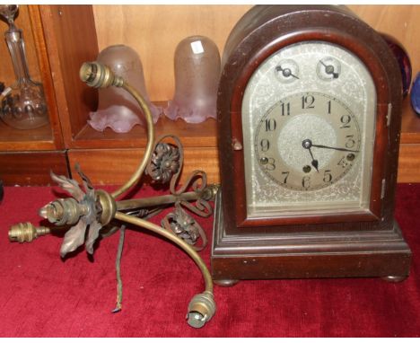 An Edwardian hardwood arched mantel clock with silvered dial, signed 'Wales and McCulloch', with German gong-striking mount, 