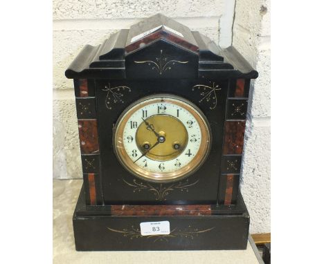 A black slate and marble mantel clock with French striking movement, 29.5cm high.