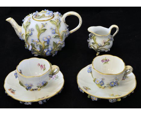 *  A 19th Century Meissen 'Tete a Tete' comprising spherical teapot, two cups and saucers and a cream jug, with applied forge