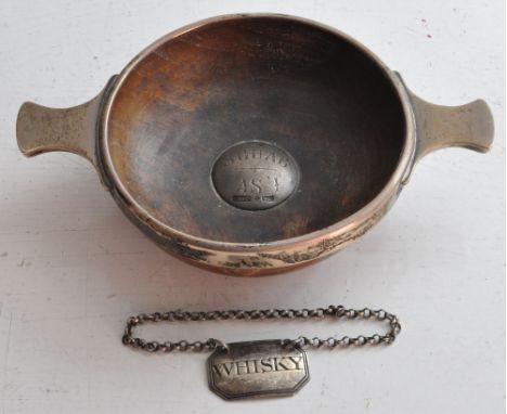 A silver mounted wooden Quaiche engraved in Gaelic and with flattened handles, and an early 19th century silver Decanter Labe