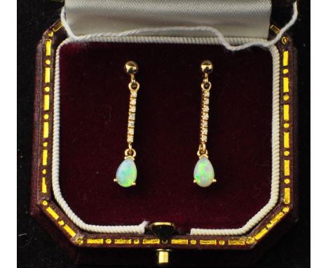 A pair of 9ct gold Pendant Earrings, each set with a pear shape opal and with diamond set suspensions.