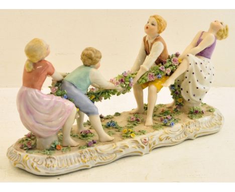 A porcelain Figure Group by Luigi Fabris of children playing tug-of-war on a floral encrusted gilt base, 10" (26cms) long.