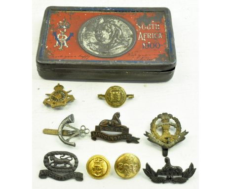 An Army Cyclist's Corps Badge, Middlesex Regiment Badge, Lincolnshire Regiment Badge, and various others in a Boer War Tin.