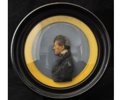 *  A 19th Century relief wax Portrait, half length of a gentleman facing left, in an ebonised and gilt circular frame, the re