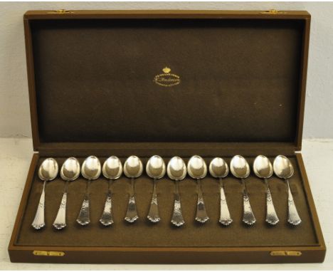 A set of twelve hammered silver Coffee Spoons with shaped finials, in a case marked for K Anderson, Stockholm.