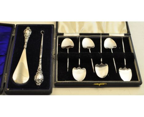 A set of six sterling silver Spoons with spade shape bowls and twisted stems and a silver handled button hook and shoehorn in