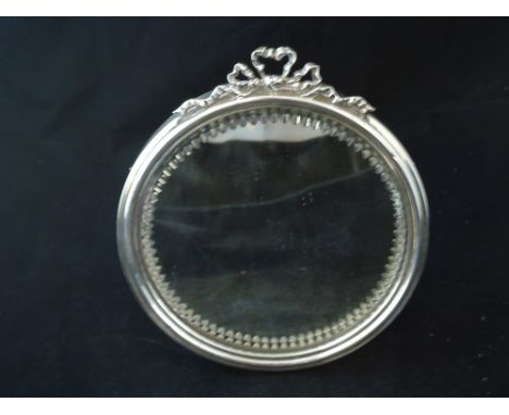 An Edwardian silver framed circular Table Mirror with tied ribbon finial and easel stand, Sheffield, 1904, maker Joseph Rodge