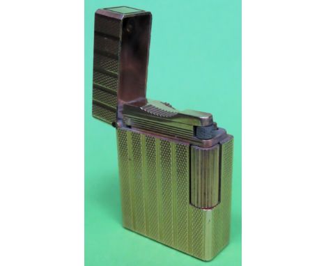 Vintage S. T. Dupont gilt table lighter with hinged cover
appears reasonable. not tested