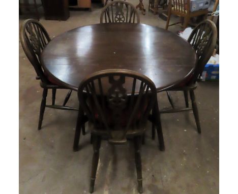 Ercol dark oak drop leaf dining table with four wheel back chairs. Table Approx. 72 x 125 x 113cms
used with minor scuffs scr