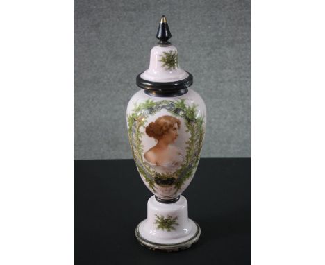 A large pale pink Victorian milk glass lidded jar, decorated with a portrait of a young woman within a fern border and black 