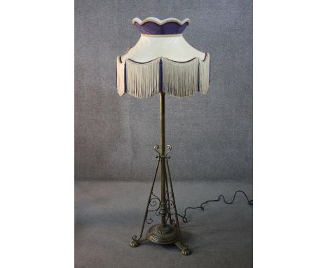 Lamp standard, 19th century brass converted to electricity with original fringed shade along with an alternative modern desig